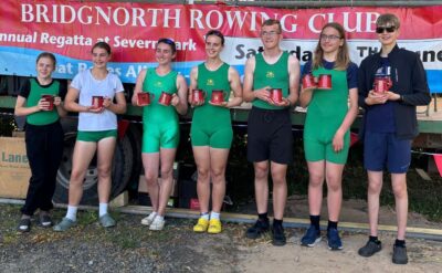 The winners display their pots