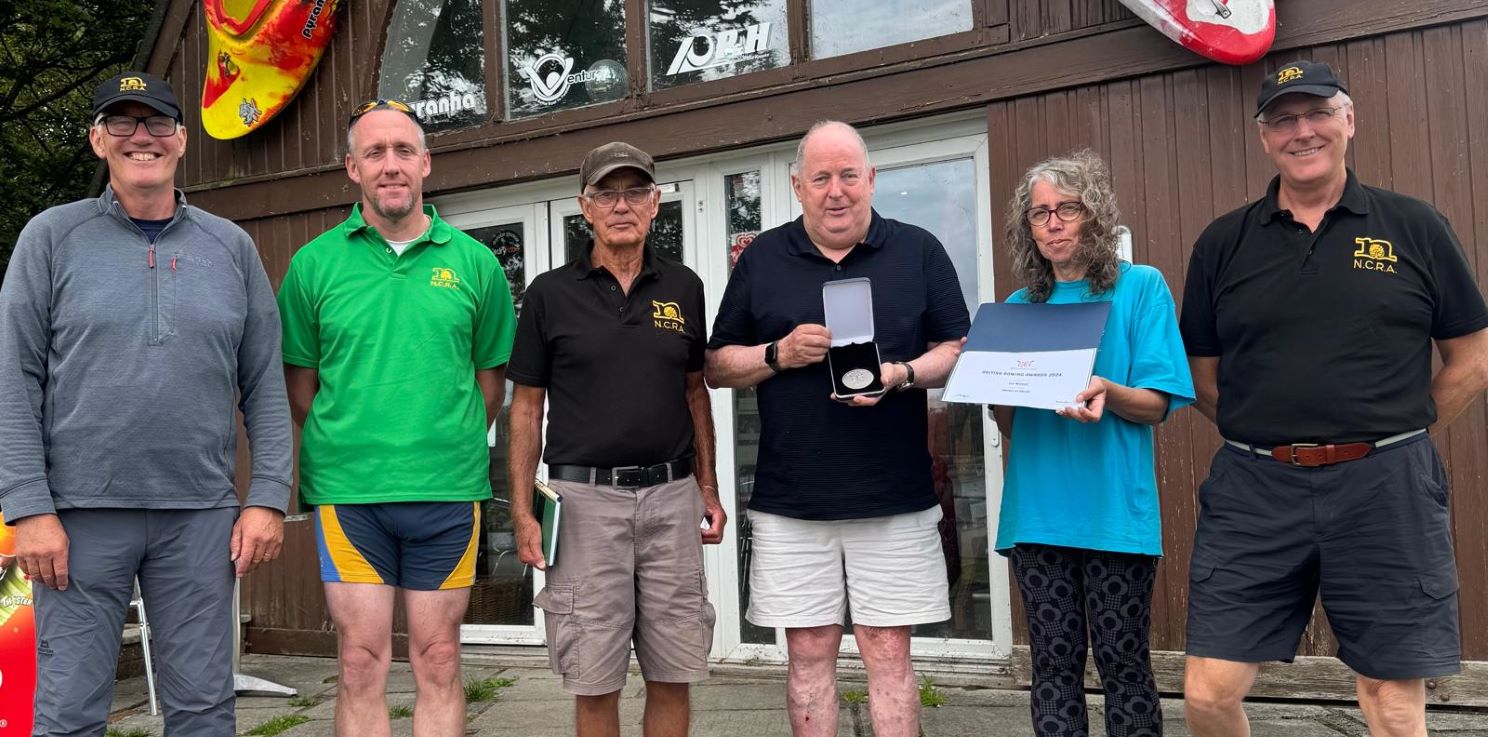 coaches-present-Ian-with-Medal-of-Merit